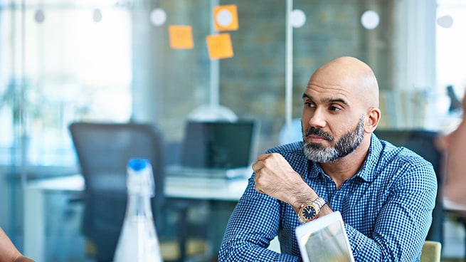 A pensative man in a meeting