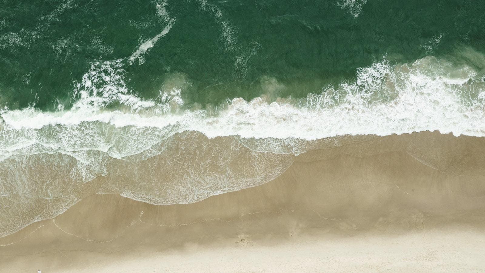 waves washing sand beach