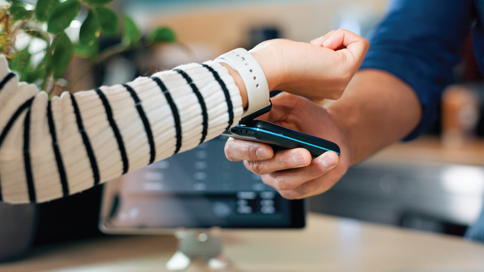 A woman paying with watch